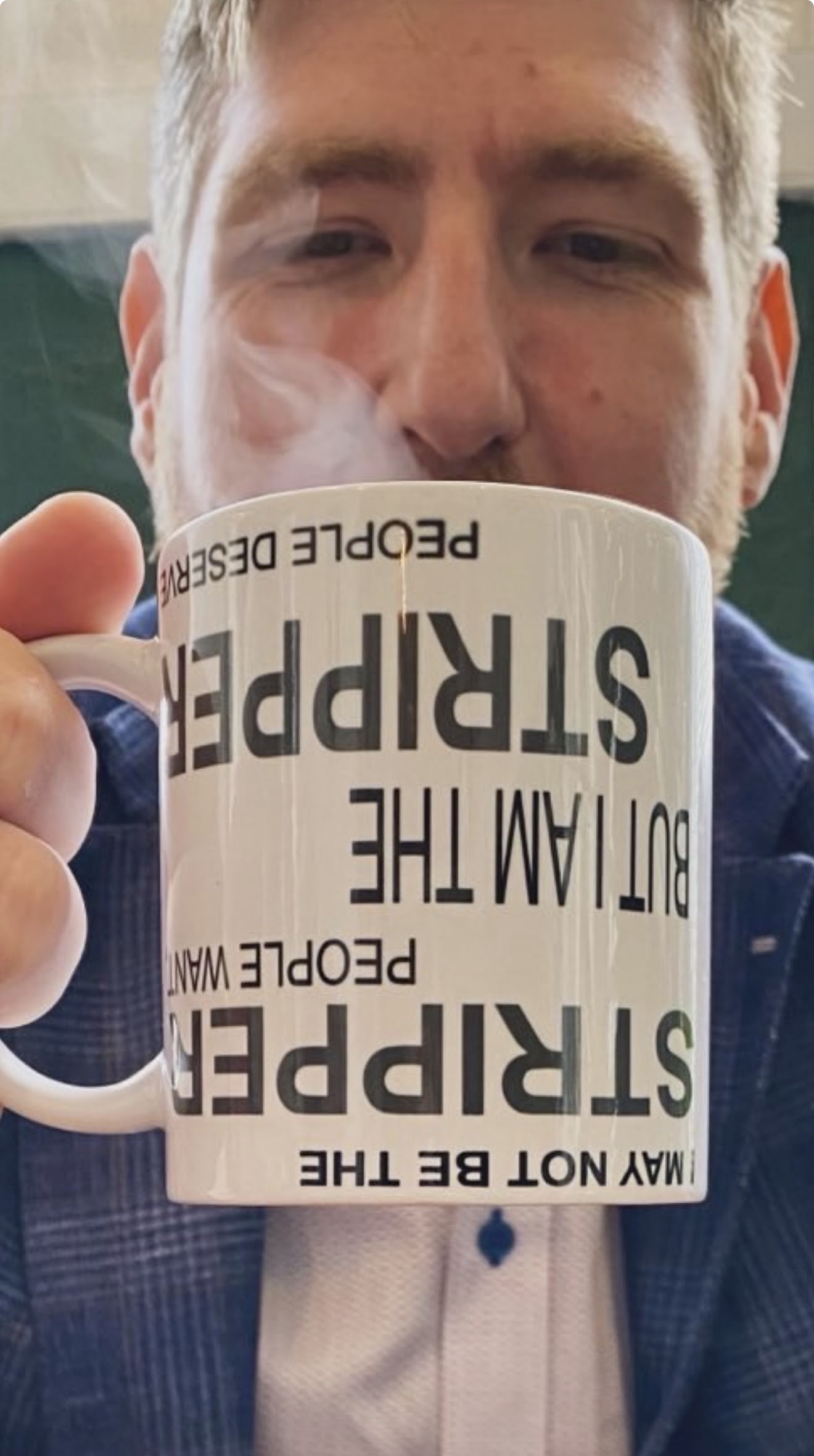 Stripper Mug held up showing the text
